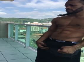 Beautiful brown boy pulls out his big dick on the balcony